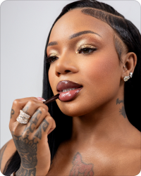 GloRilla applying a finishing touch to her makeup